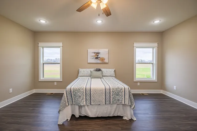 a bathroom with a granite countertop sink a toilet and a mirror