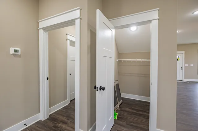a view of an empty room with wooden floor