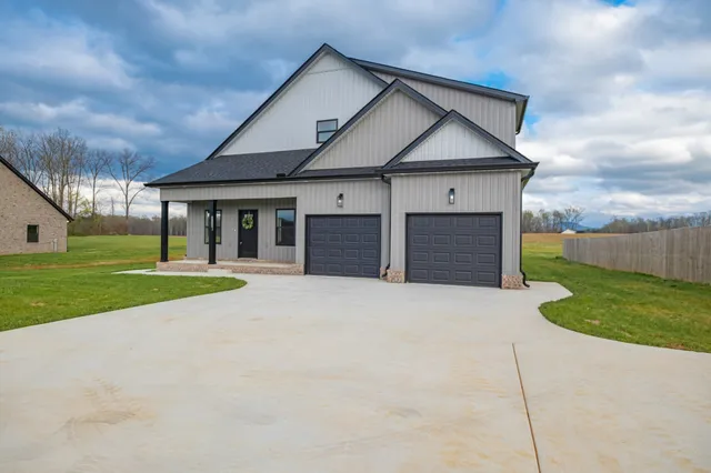a view of a house with a yard and garage