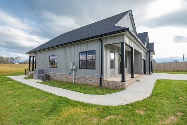 a front view of a house with swimming pool having outdoor seating