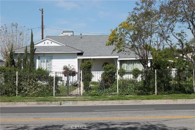 a view of a house with a small yard and plants
