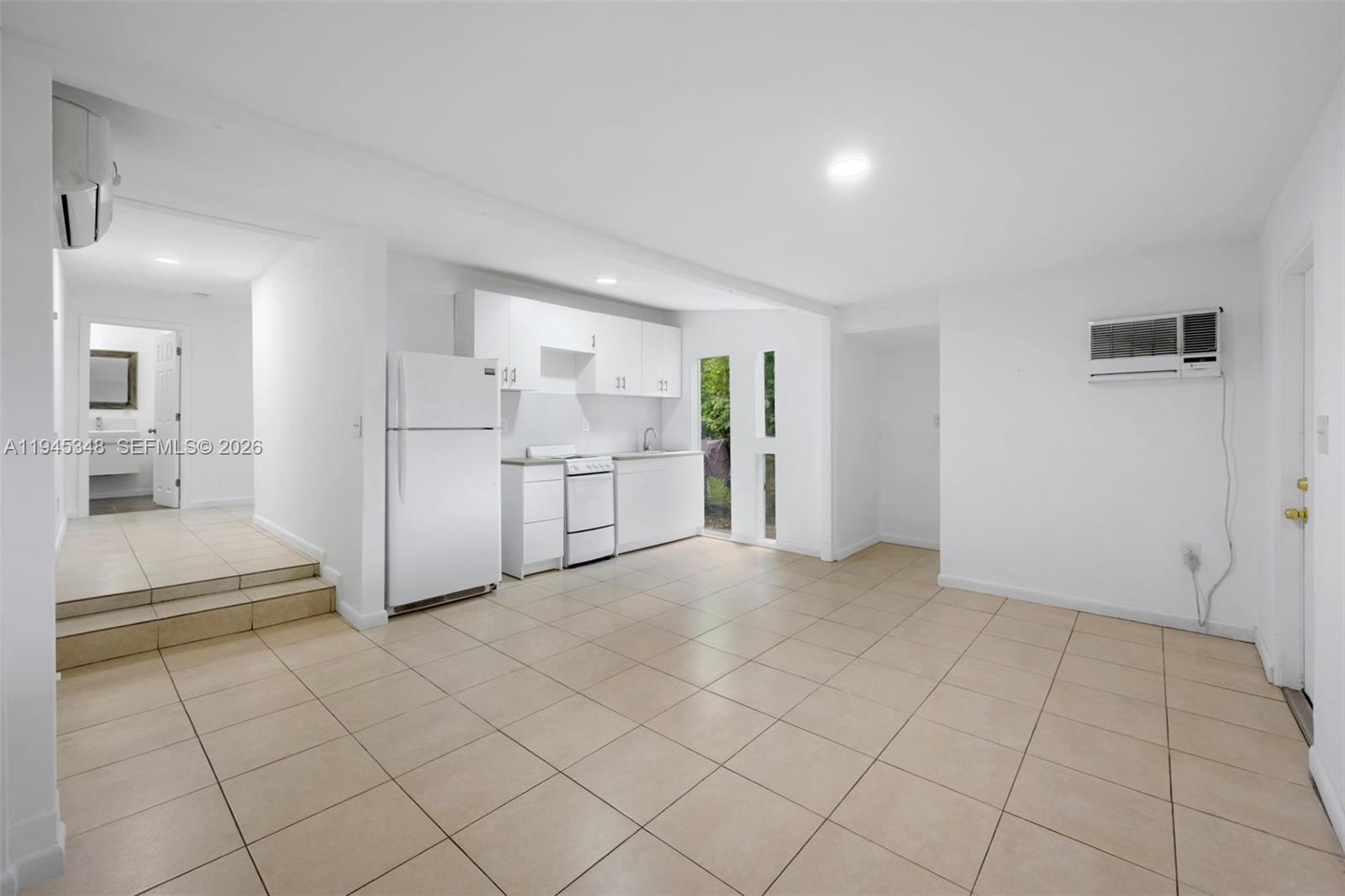 348 Northeast 58th Street Miami, FL 33137 - Photo 1 of 16 a view of a kitchen with white cabinets and refrigerator