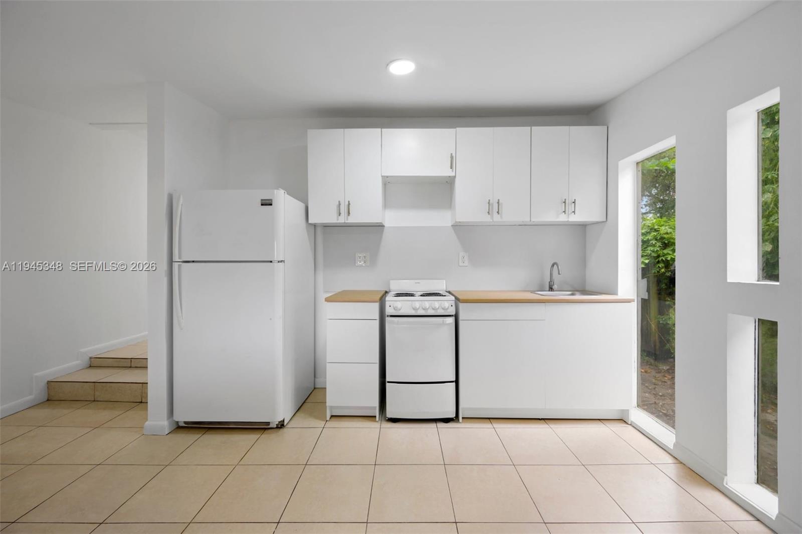 348 Northeast 58th Street Miami, FL 33137 - Photo 11 of 16 a utility room with cabinets washer and dryer