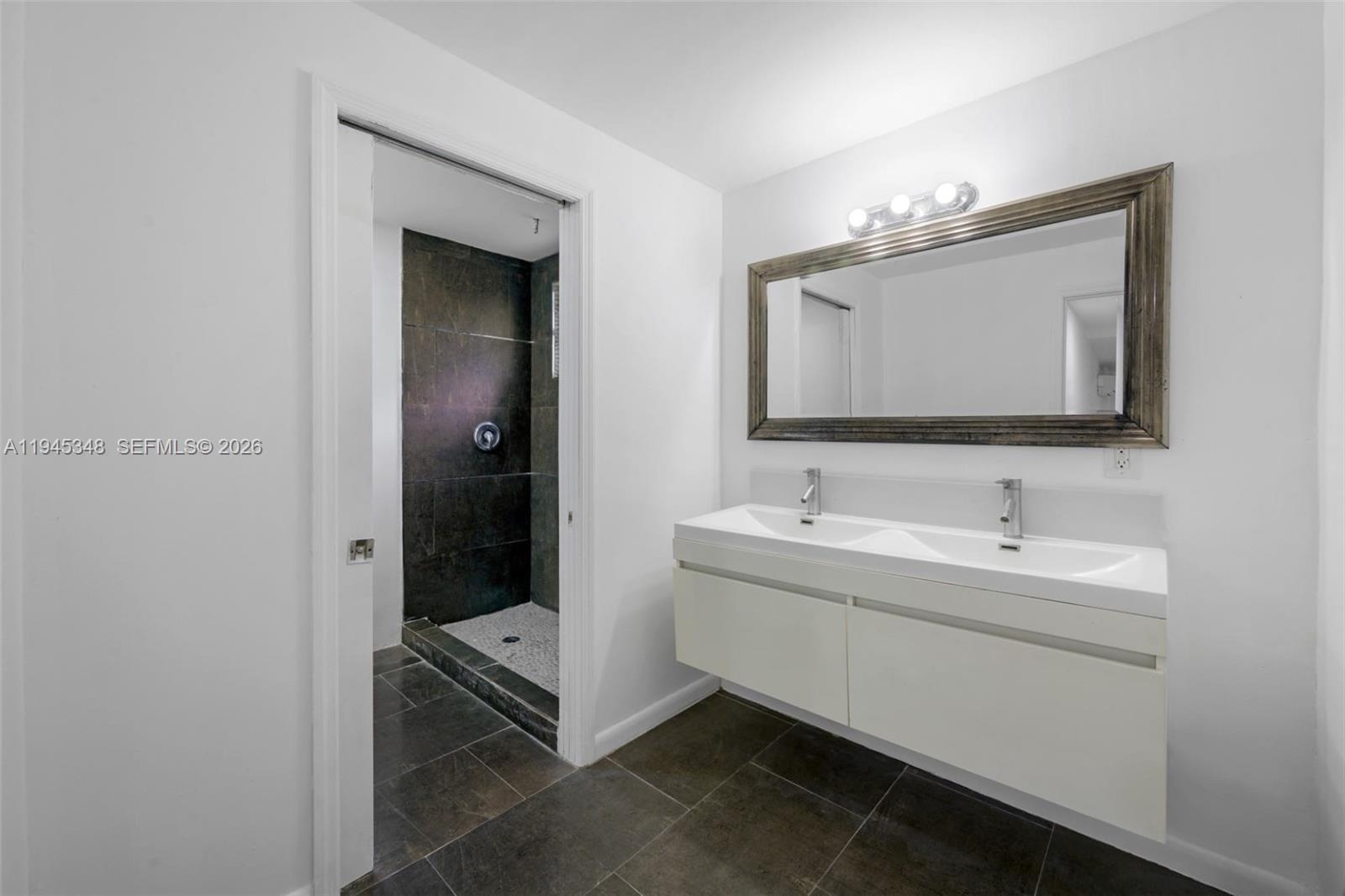 348 Northeast 58th Street Miami, FL 33137 - Photo 12 of 16 a bathroom with 2 sink and a mirror