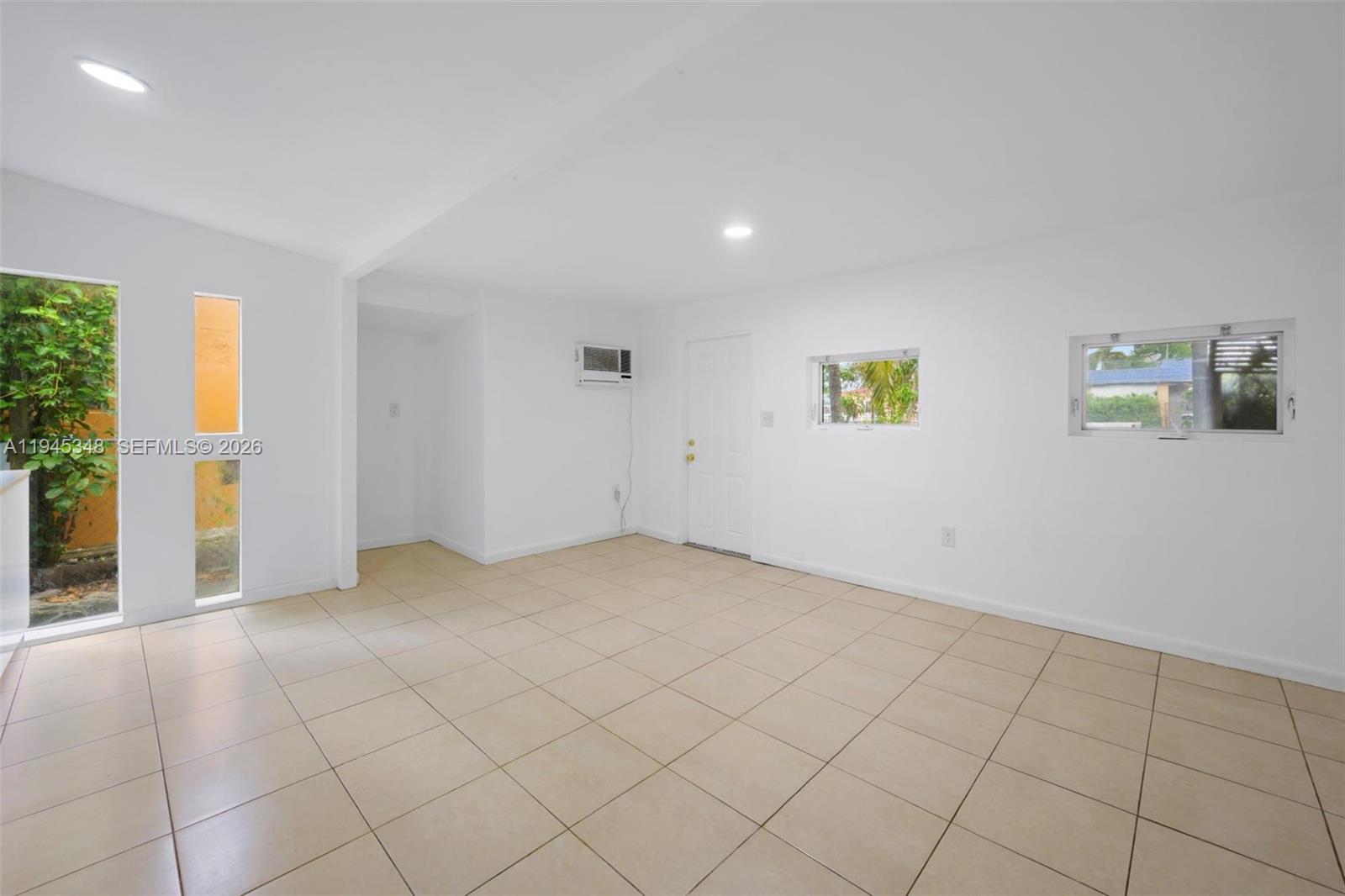 348 Northeast 58th Street Miami, FL 33137 - Photo 6 of 16 an empty room with windows