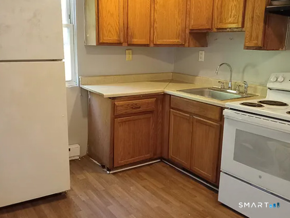 88 Olive Street Meriden, CT 06450 - Photo 3 of 7 a kitchen with a sink cabinets and appliances