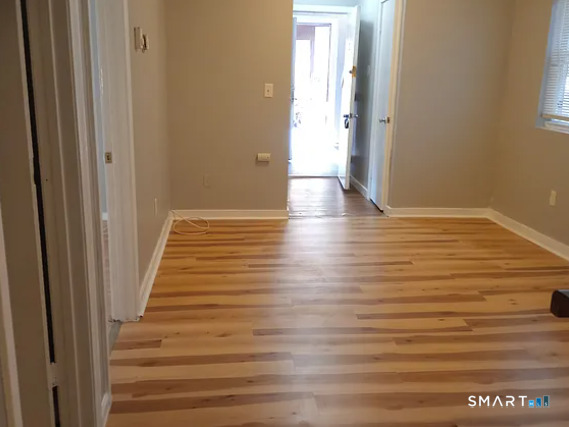 88 Olive Street Meriden, CT 06450 - Photo 5 of 7 a view of an empty room with wooden floor