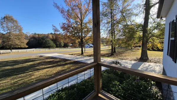 a view of a yard with wooden fence