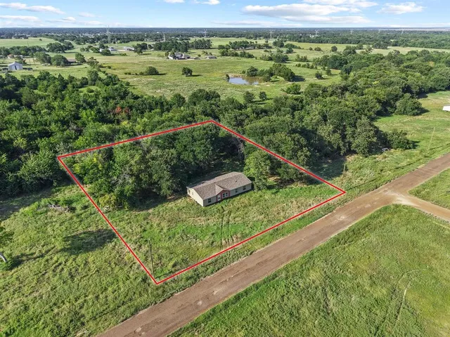 a view of a green field with sitting area