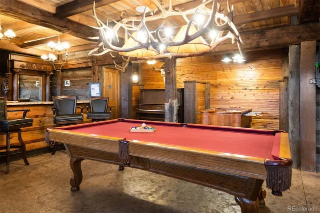 a room with pool table and windows