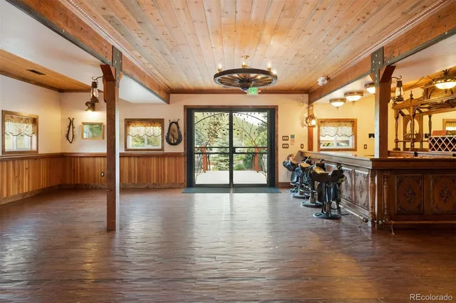 a view of a livingroom with furniture wooden floor and windows