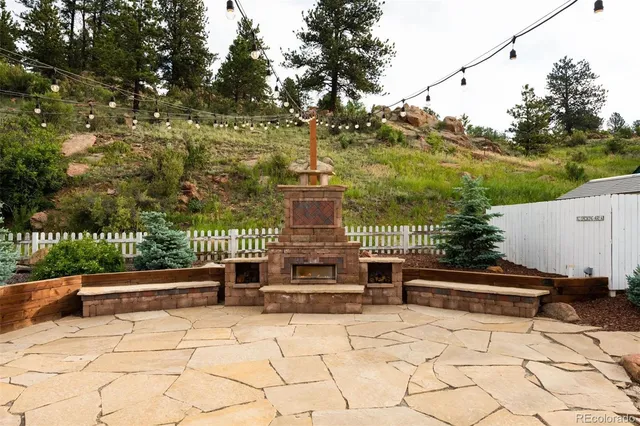 a roof deck with a bench and trees