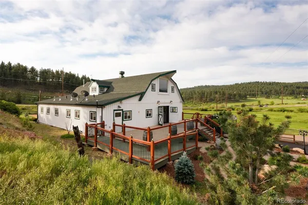 a view of a house with a yard and lake view