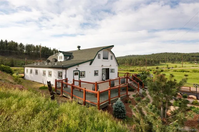 a view of a house with a yard and lake view