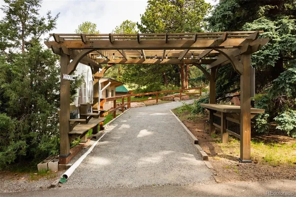 a view of a patio with table and chairs with wooden floor and fence