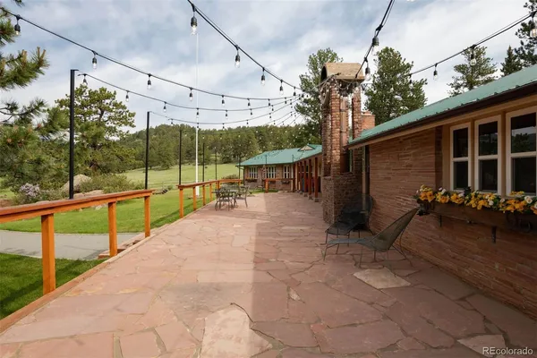 a view of a porch with furniture and garden