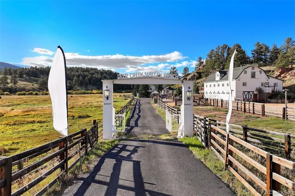 a view of a balcony with floor to ceiling windows yard and wooden floor
