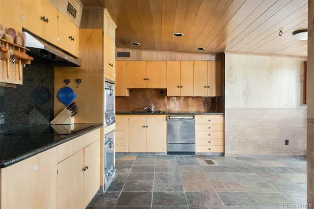 a kitchen with a refrigerator and cabinets
