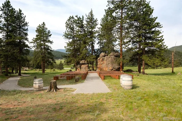 a white house that has a tree in front of it