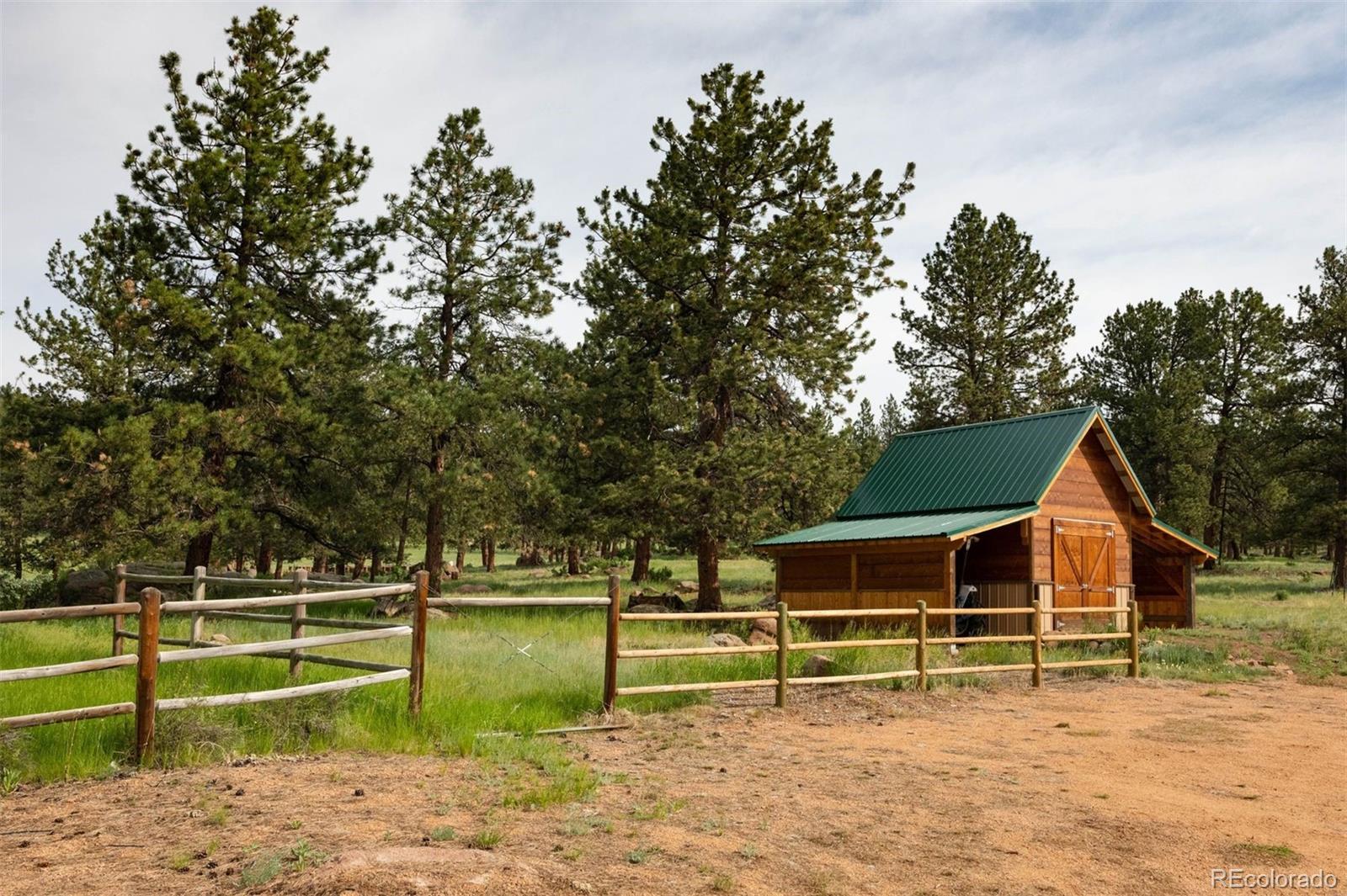 64057 US Highway 285 Bailey, CO 80421 - Photo 44 of 50 a white house that has a tree in front of it