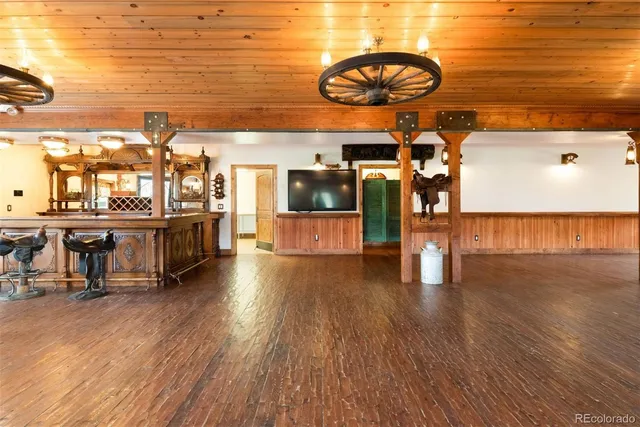 a view of a room with kitchen island and wooden floor