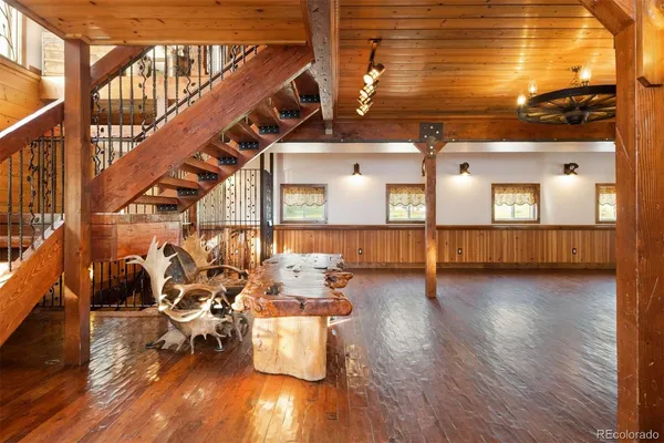 a view of a living room and dining room with wooden floor