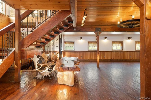 a view of a living room and dining room with wooden floor