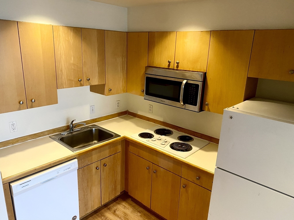 131 Tremont Street, Unit 5B Boston, MA 02111 - Photo 1 of 24 a kitchen with a sink and cabinets
