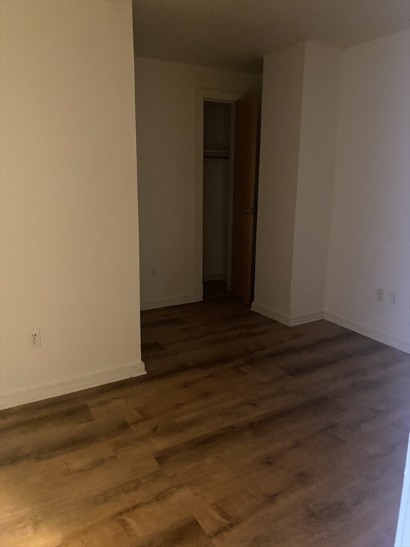 131 Tremont Street, Unit 5B Boston, MA 02111 - Photo 17 of 24 a view of an empty room with wooden floor