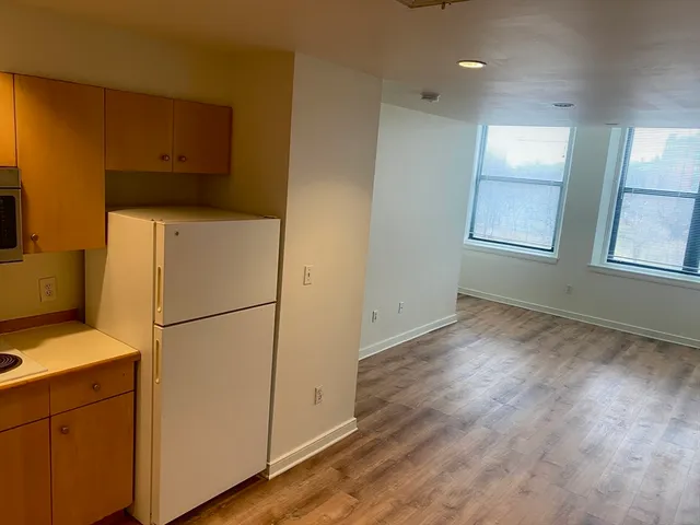 a utility room with wooden floor and electronic appliances