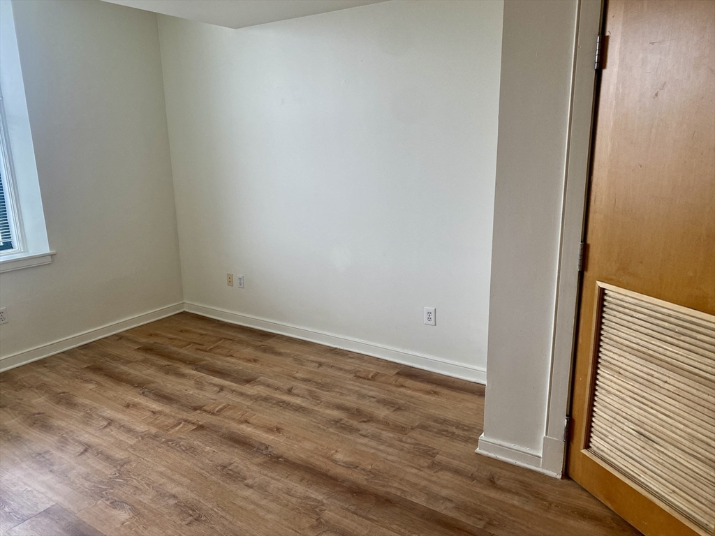 131 Tremont Street, Unit 5B Boston, MA 02111 - Photo 8 of 24 a view of empty room with wooden floor