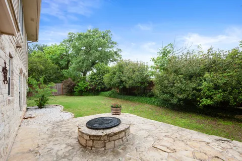 a view of a backyard with plants and a garden