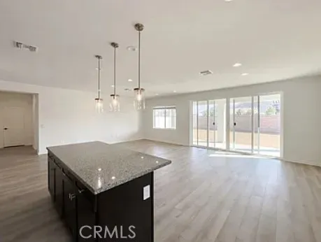 a view of a room with wooden floor and windows