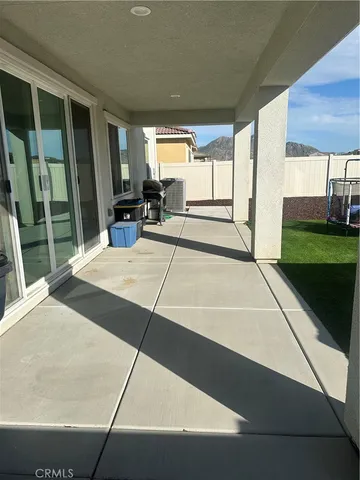 a view of a hallway with white walls and windows