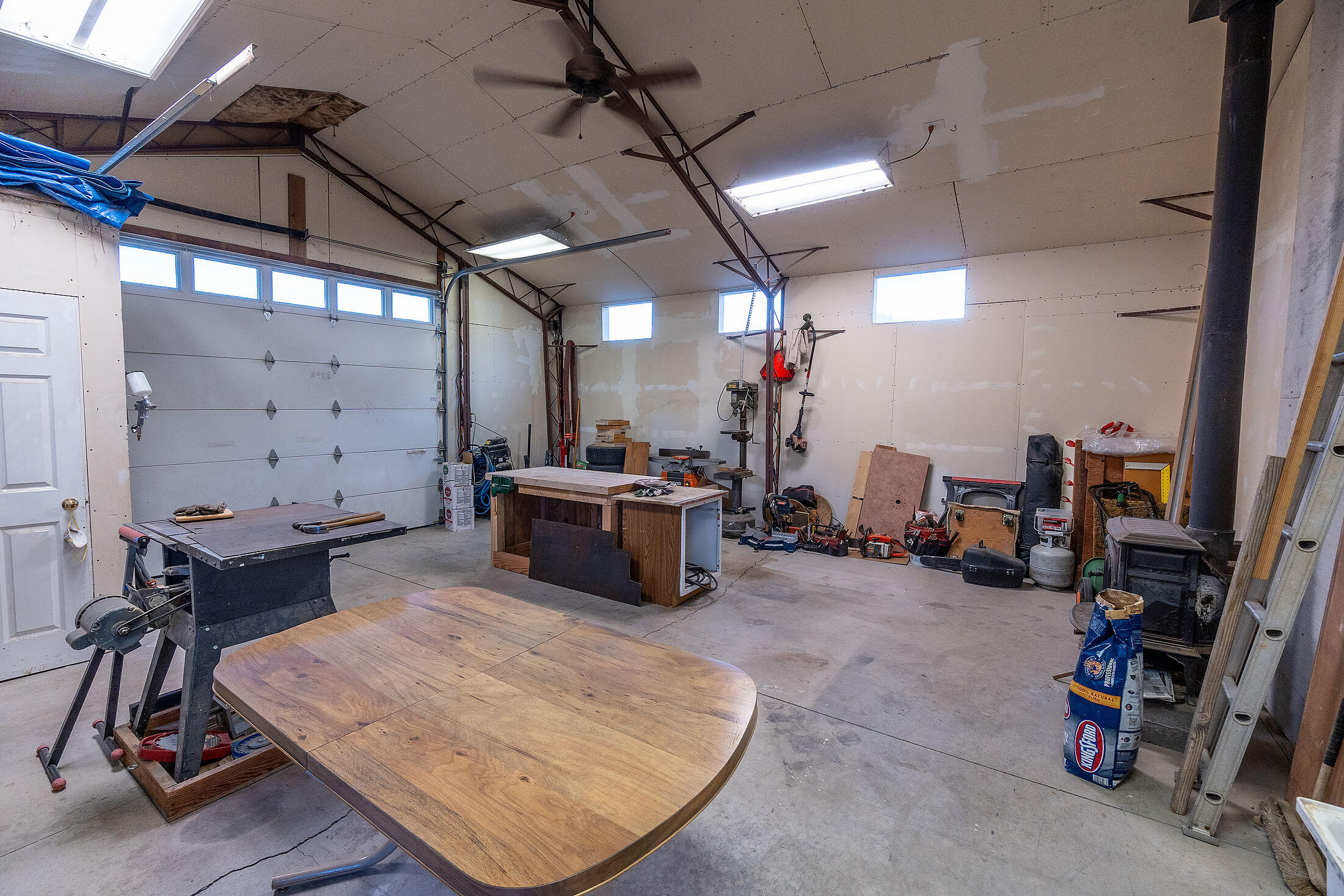 411 Northwest Mc Donald Road Prineville, OR 97754 - Photo 22 of 47 Shop has sheetrock and insulation, pressure tank room, permitted wood stove, ceiling fan to move the heat, and an entry to the office/apartment.