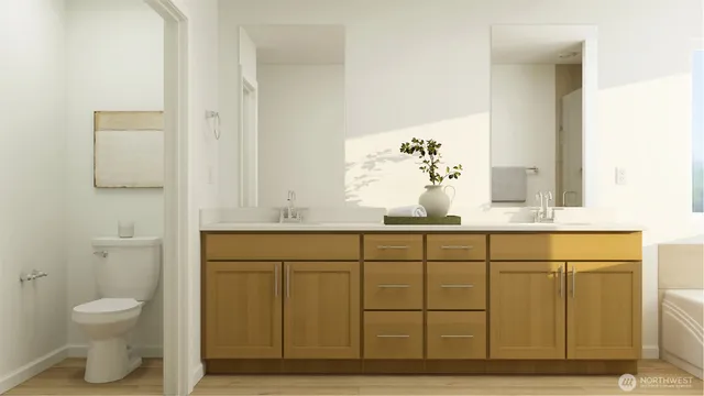 a bathroom with a sink a toilet and mirror