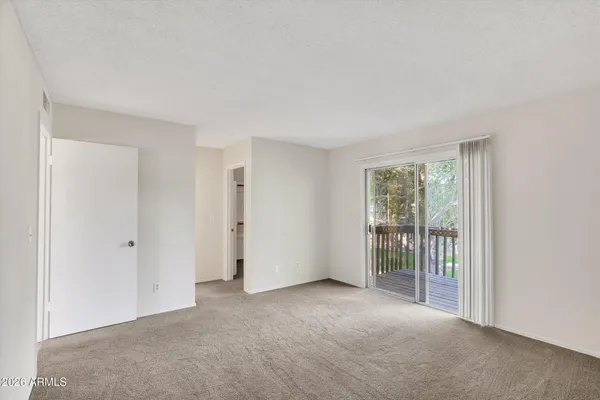 a view of an empty room with glass door