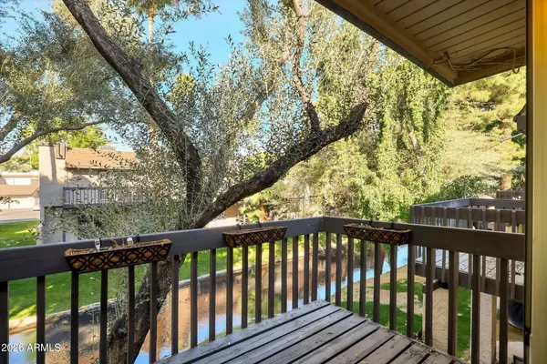 a view of a balcony with wooden floor