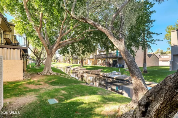 a view of a house with a yard and sitting area