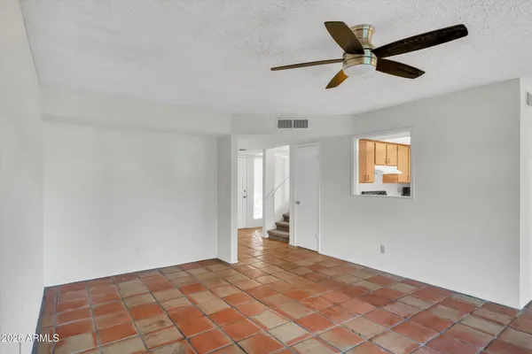 a view of a livingroom with a ceiling fan and window
