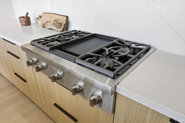 a living room with furniture large windows a rug and a potted plant