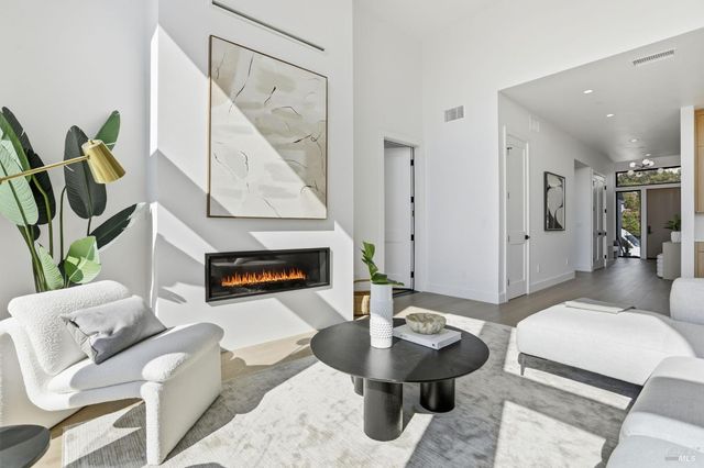 a view of a patio with table and chairs with wooden floor and fence