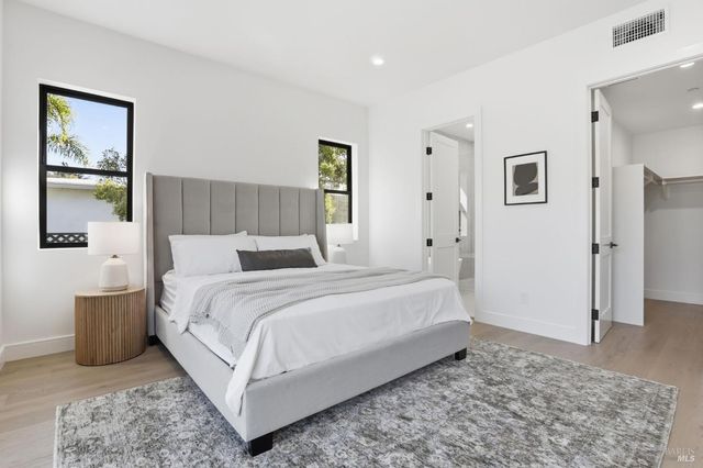 a bedroom with a bed and wooden floor
