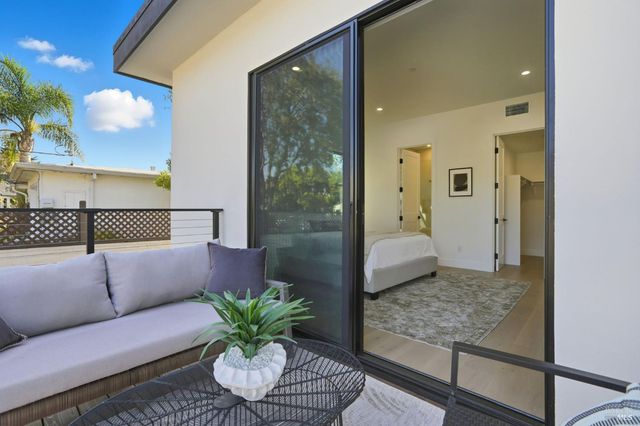 a bedroom with a bed and a painting on the wall