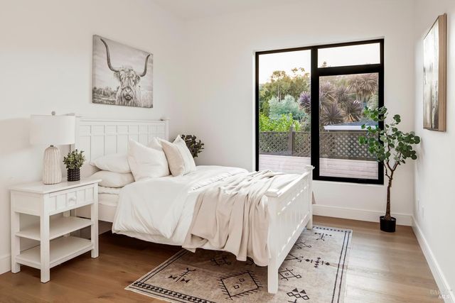 a kitchen with stainless steel appliances granite countertop a dining table chairs and a refrigerator