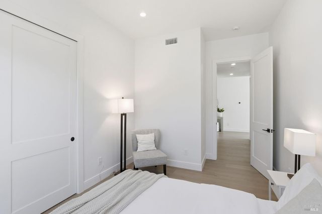 a bedroom with a bed and lamp