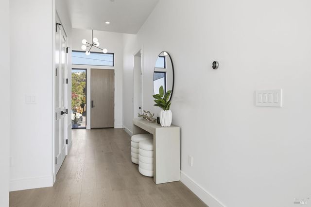 a large white kitchen with a large window and stainless steel appliances