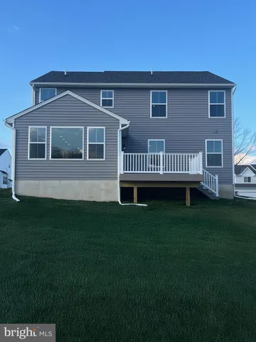 a kitchen with counter top space sink and wooden floor