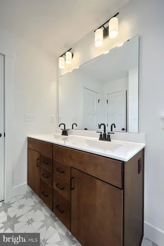 a bathroom with a sink a toilet and a mirror