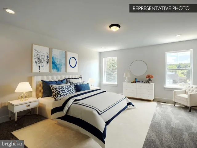 a bedroom with a large bed and wooden floor